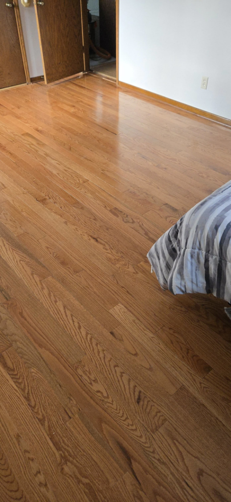 Newly installed hardwood floor in a bedroom by Schwoegler Remodeling in Madison, WI