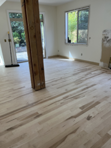 A spacious room showcasing newly installed hardwood flooring by Birdseye Hardwoods LLC in Portland, OR