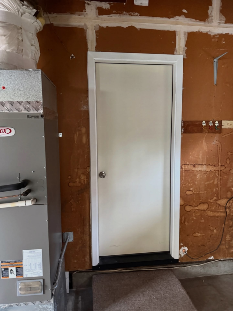 A newly installed white interior door in a room with unfinished walls, showcasing a handyman service by Bashful Bob's, Inc. in Philomath, OR.