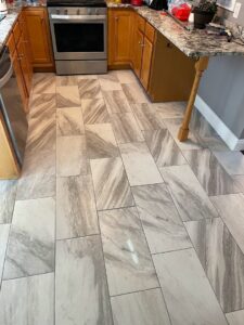 Newly installed tile flooring in a kitchen by Wood Trades LLC in Westport, MA.