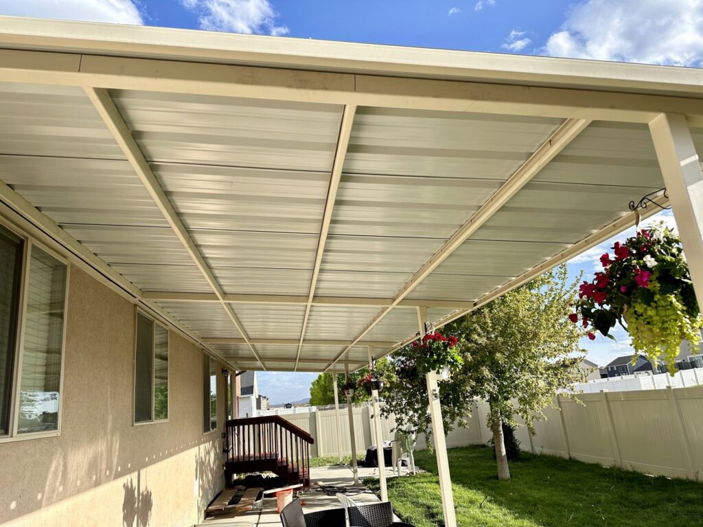 A newly installed metal patio cover attached to a house, a service provided by Jeremy's Welding & Handyman in West Jordan, UT.