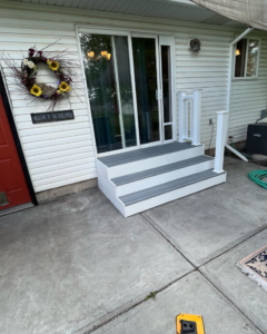 Newly installed outdoor stairs with white risers and grey treads by Un1que.homes in Idaho Falls, ID.