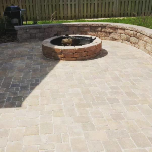 A newly installed paver patio with a built-in fire pit and retaining wall by Keystone Design in Tallahassee, FL.