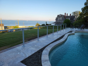 Newly installed cable railing system around a swimming pool by Easy Contracting LLC in Quincy, MA.