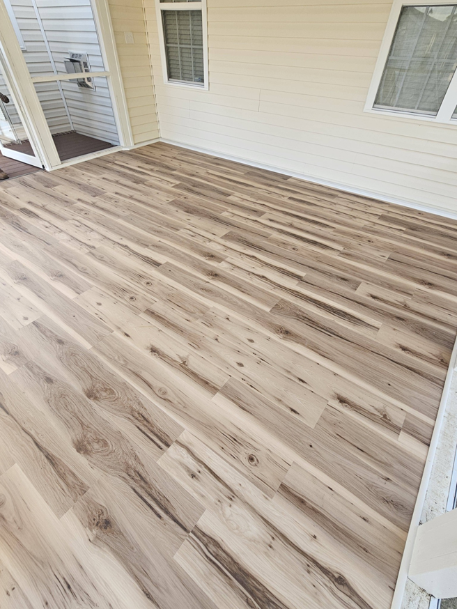 Newly installed light wood-look flooring in a screened porch by TruBuilt Contracting LLC in Cary, NC