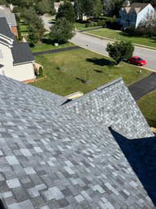 A newly installed residential roof with gray shingles, completed by New American General Construction INC in Richmond, VA.