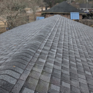 A close-up view of newly installed dark grey asphalt roof shingles by Caliber Roofing LLC in Meridian, ID.