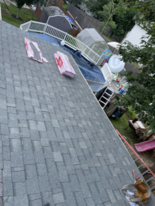 A newly installed roof with gray shingles and materials, showcasing quality roofing work by Kznconstructionllc in Johnston, RI.