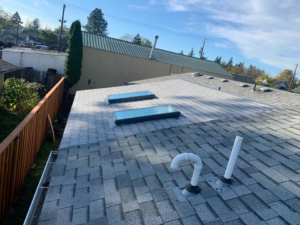 Newly installed shingle roof with two skylights by All in One Remodeling Services LLC in East Sandwich, MA