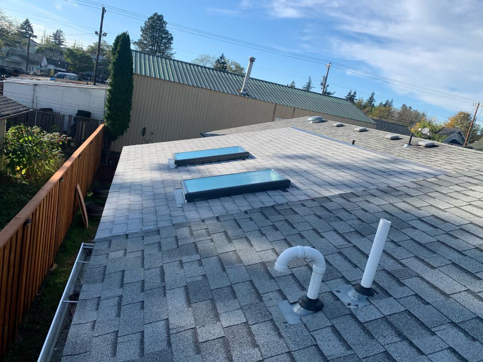Newly installed shingle roof with two skylights by All in One Remodeling Services LLC in East Sandwich, MA