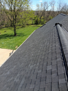 A newly installed dark gray shingle roof on a residential home by Elegant Home Exteriors in Flourance, KY.
