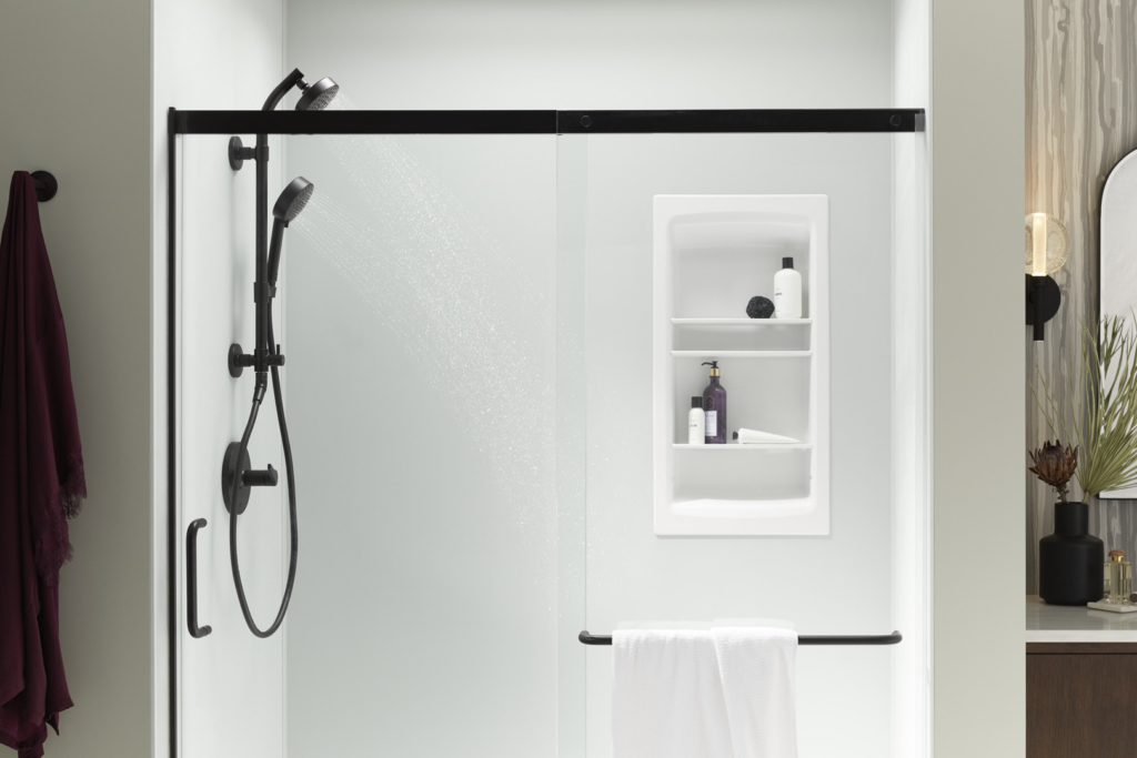A newly installed shower with a black frame and built-in shelves by Pacific Bath in Portland, OR.