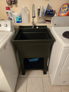 A newly installed utility sink in a laundry room by Sure Can LLC Handyman Services in South Charleston, WV.