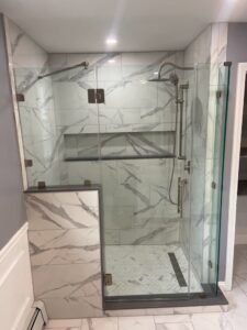 A newly installed walk-in shower with glass doors by Wood Trades LLC in Westport, MA.