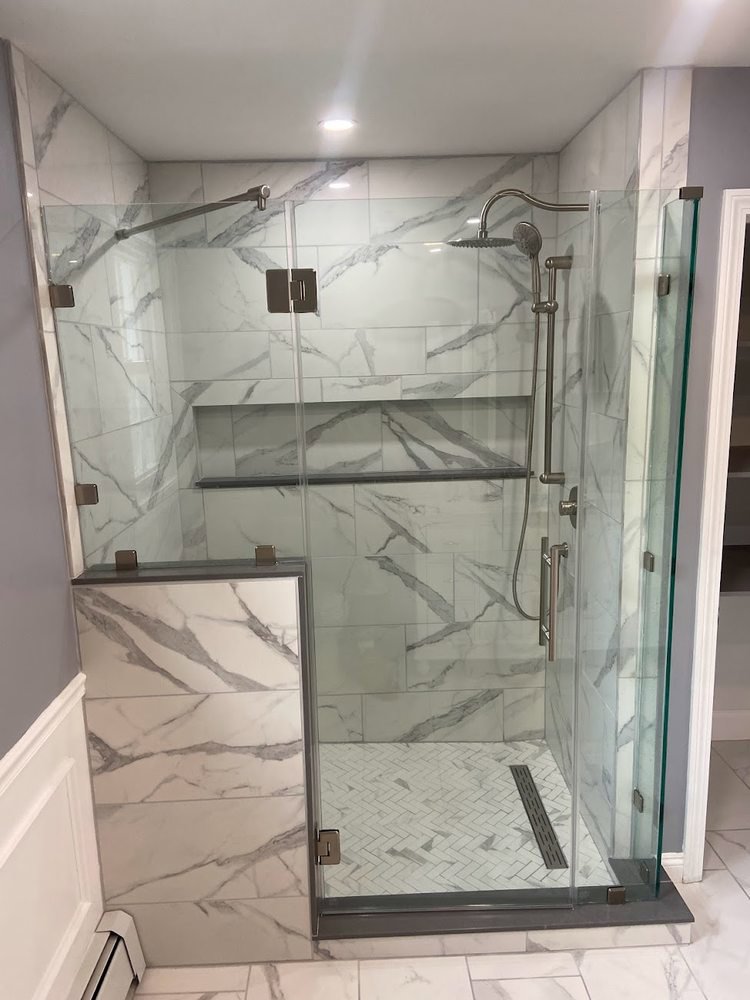 A newly installed walk-in shower with glass doors by Wood Trades LLC in Westport, MA.