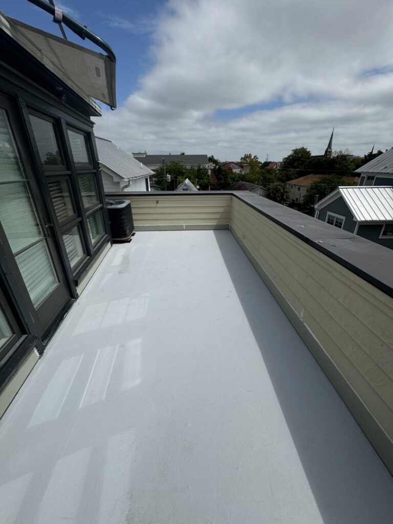 A clean, newly installed white flat roof or deck surface by Coastal Roofing Solutions LLC in Charleston, SC.