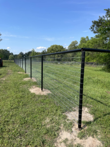 A newly installed wire fence with black metal posts, showcasing general contractor work by SJ Construction Services LLC in Austin, TX.