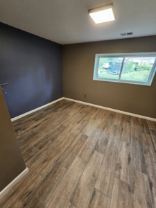 A newly installed wood-look tile flooring in a renovated room by AIS Home Service's in St. Louis, MO.