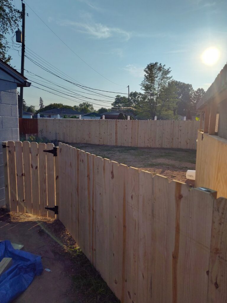A newly installed wooden privacy fence in a backyard by Jarrett's Home Improvements & Maintenance Services in Columbus, OH