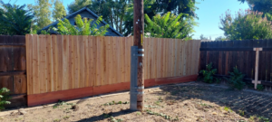 A newly installed wooden backyard fence, demonstrating quality craftsmanship by Montano's Handyman in Fresno, CA