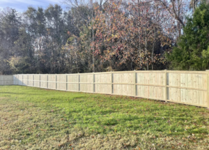 A newly installed wooden privacy fence in a backyard, built by RJS Custom Decks in Cibolo, TX.