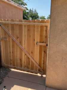 A newly installed wooden fence gate, a completed project by Ace Handyman ABQ SF in Albuquerque, NM