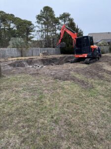 Newly installed wooden fence and gate with wire mesh by Port City Remove and Improve in Wilmington, NC