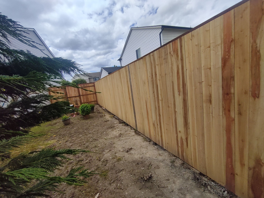 A newly installed wooden fence providing privacy and security, completed by JJU Property Maintenance, LLC in Salem, OR.