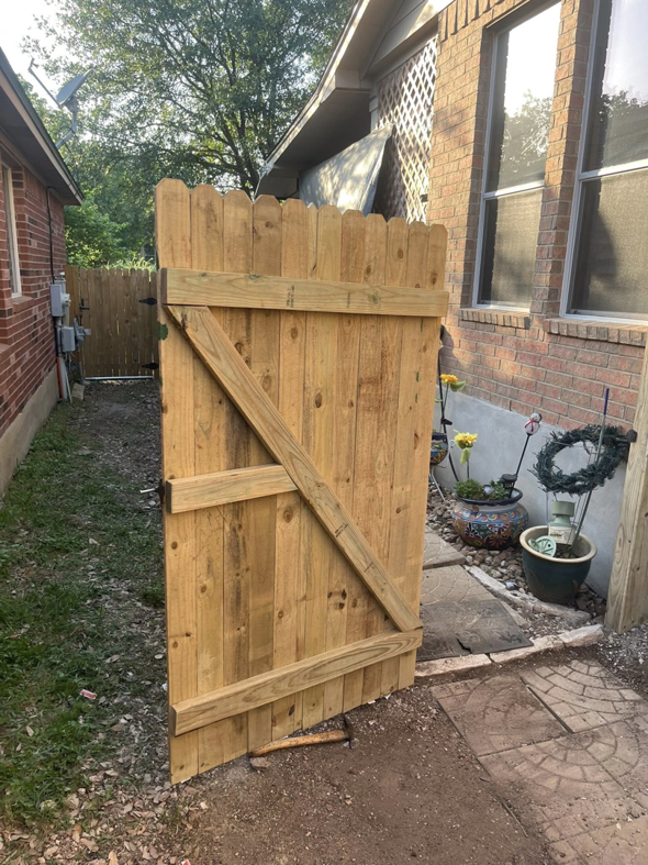A newly installed wooden gate, part of a fence project completed by Triple A' Construction in San Antonio, TX.