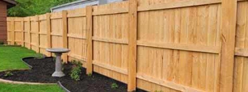 A newly installed wooden privacy fence in a residential backyard by Fox Valley Fencing LLC in Appleton, WI