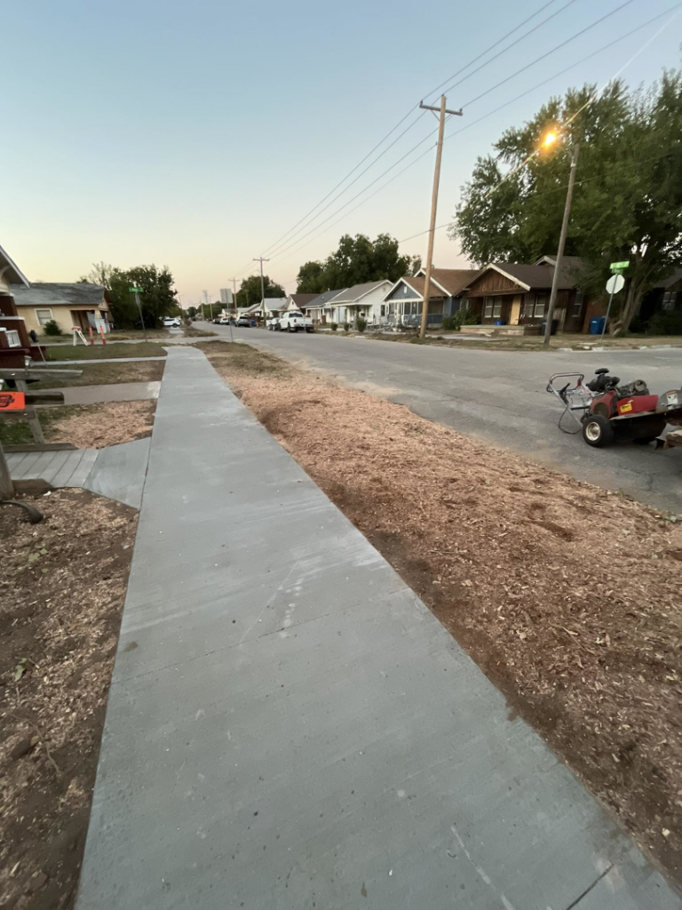 Newly laid concrete sidewalk and mulched strip along a street by Reasonable Tree Service in Concord, CA.