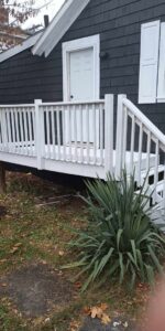 Close-up of a newly painted white deck railing and steps, part of an exterior renovation by NS Construction in Imperial, CA.