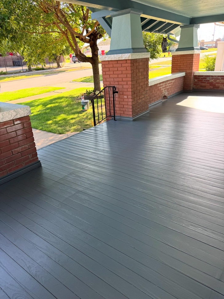 A newly painted grey porch floor and steps, showcasing a completed exterior painting job by Pro Touch Painting Inc. in Oklahoma City, OK.