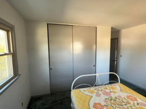 A newly painted interior room featuring new grey sliding closet doors installed by Lambert's Residential Painting And More LLC in Fort Wayne, IN.