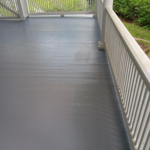 A newly painted grey porch floor and white railings completed by Carter's painting in Martinsburg, WV.