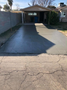 A newly poured concrete driveway installation completed by Ken's Masonry, LLC in Chandler, AZ.