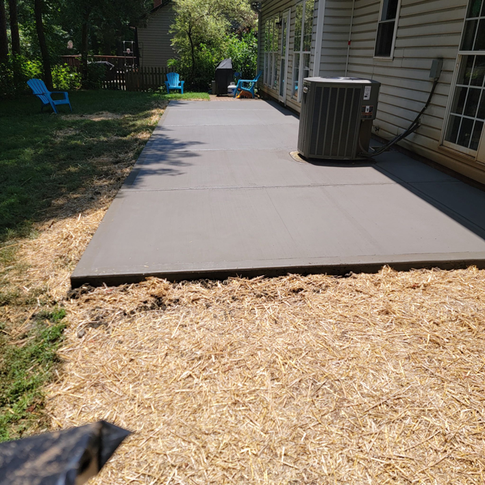 A newly poured concrete patio installed by Swift Remodeling South in Charlotte, NC.