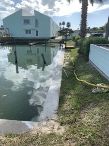 A newly poured concrete seawall along a waterway by Complete Foundation Repairs in Corpus Christi, TX.