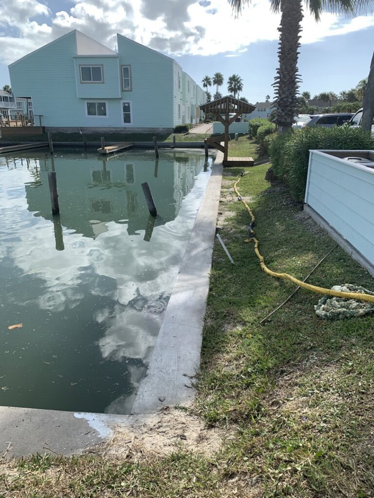 A newly poured concrete seawall along a waterway by Complete Foundation Repairs in Corpus Christi, TX.