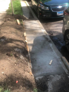 A newly poured concrete sidewalk section with wooden forms in place by Pro Home Solutions in Aiken, SC.