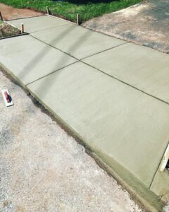 A newly poured concrete sidewalk or pathway with expansion joints by S-G General Contracting LLC in Philadelphia, PA.