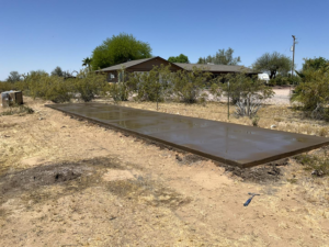 A newly poured concrete slab in a backyard by Martin Jr's concrete in Surprise, AZ