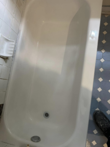 A newly refinished white bathtub with clean tiles, showcasing quality work by Snell & Sons Construction LLC in Mobile, AL.