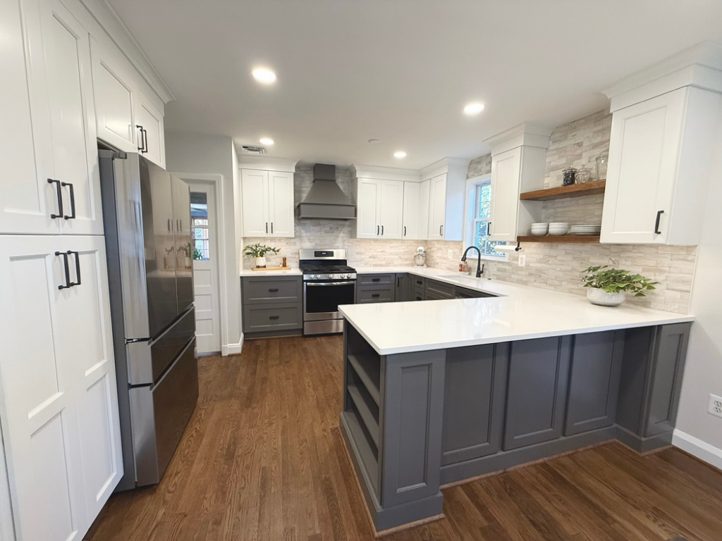 A newly remodeled kitchen featuring white and gray cabinets, new appliances, and a modern backsplash by Chesapeake Premier Remodeling in Baltimore, MD