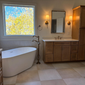 A newly renovated bathroom featuring a freestanding tub and modern vanity by Berco Construction LLC in Godfrey, IL