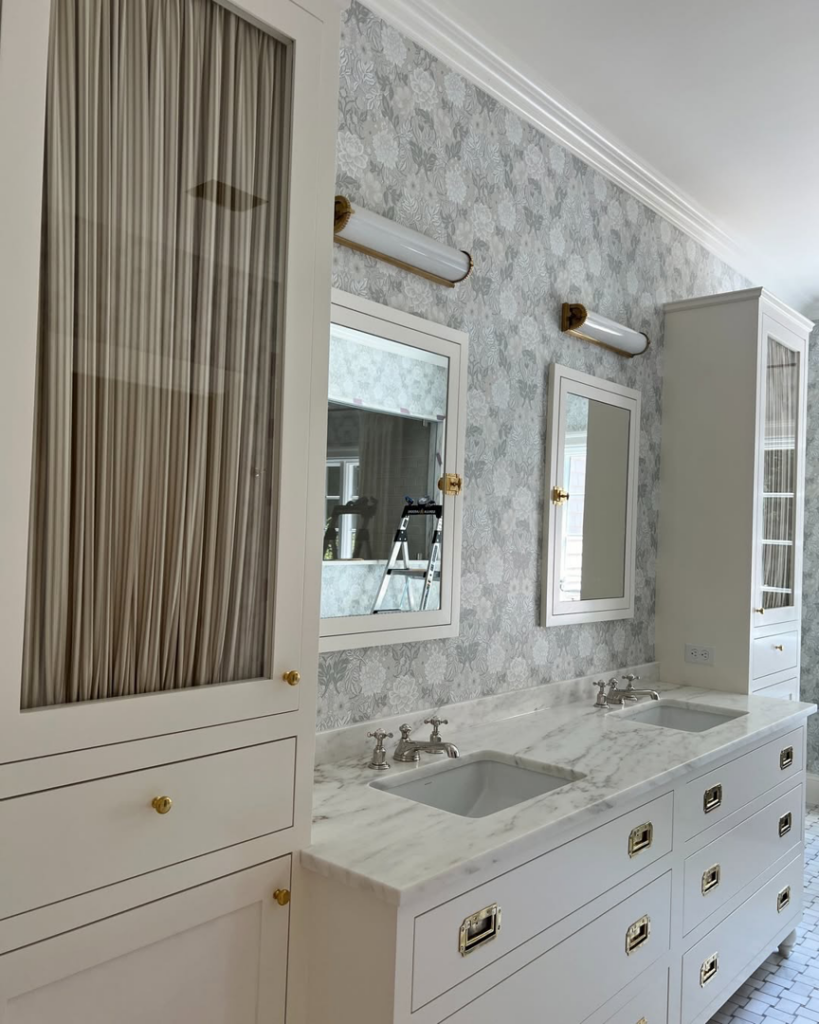 A newly renovated bathroom featuring a double vanity and marble countertop by Kevin Cradock Builders in Boston, MA.