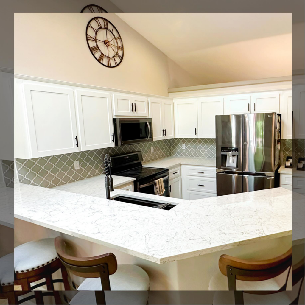 A newly renovated kitchen with white cabinets and a large island completed by Love Anchor Construction LLC in Vancouver, WA.