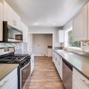 A newly renovated kitchen with white cabinets and stainless steel appliances by Johnson Handyman Services in Anderson, SC.