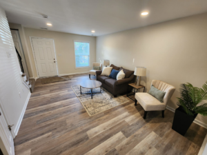 A newly renovated living room with new flooring and fresh paint by 4A Contracting and Home Improvement Specialists in Frederick, MD