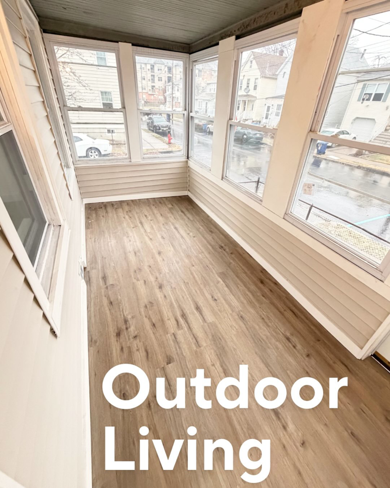 A newly renovated outdoor living space with new flooring and windows by I Revive Homes in Edison, NJ.
